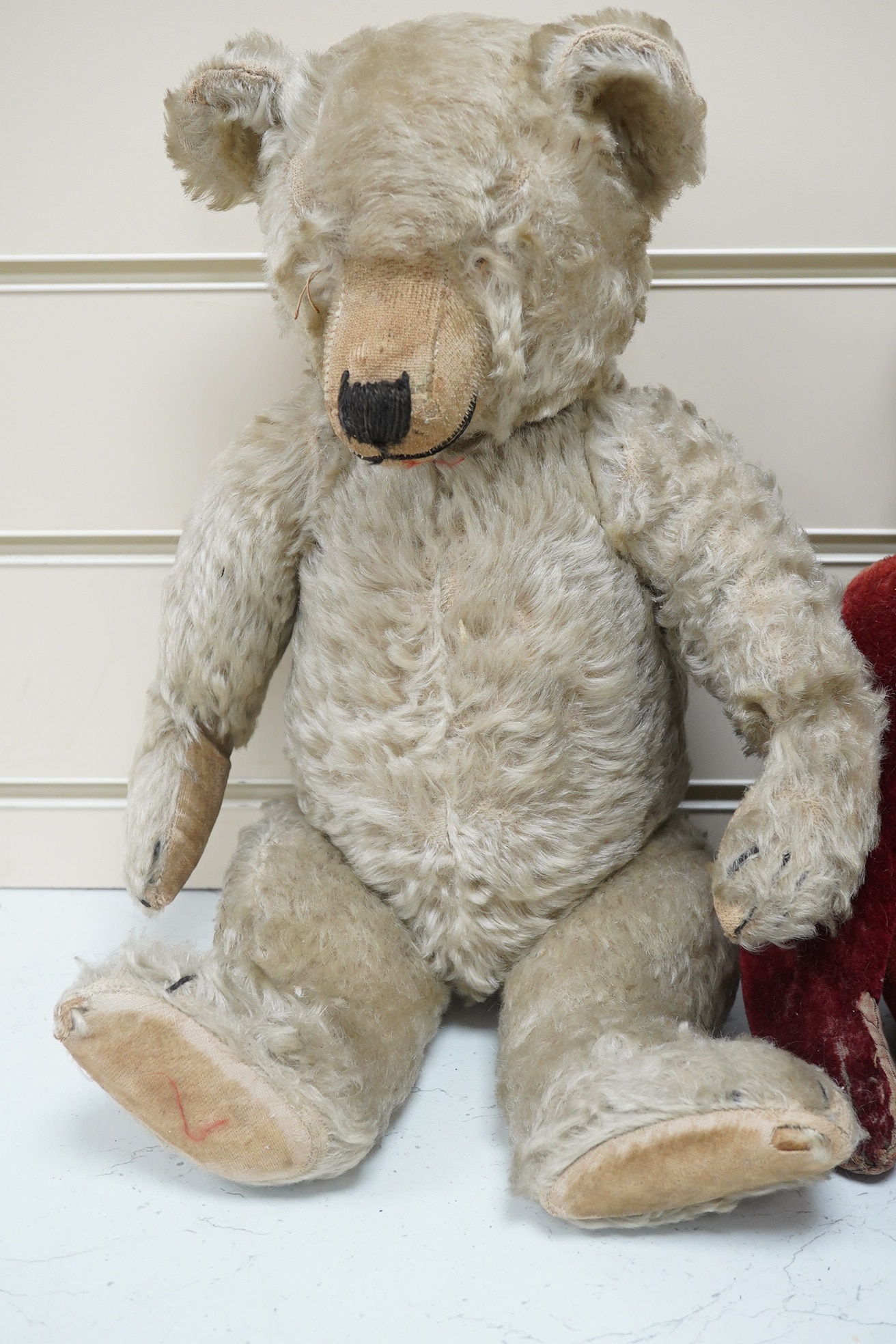 Three bears, one Chiltern 1950's. Condition - good, missing eyes, height 46cm, 1930's plush ear, button eyes. Condition - faded, height 42cm, 1930's bear, height 40cm. Condition - poor.